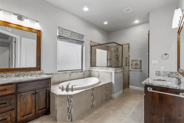 bathroom with tile patterned flooring, vanity, and separate shower and tub