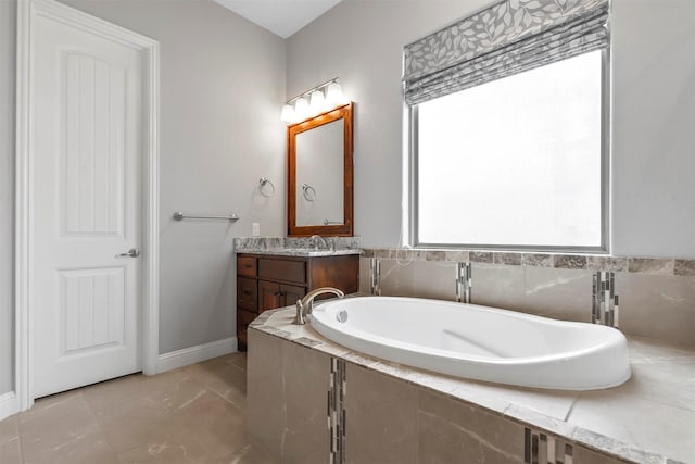 bathroom with vanity, a relaxing tiled tub, and tile patterned floors