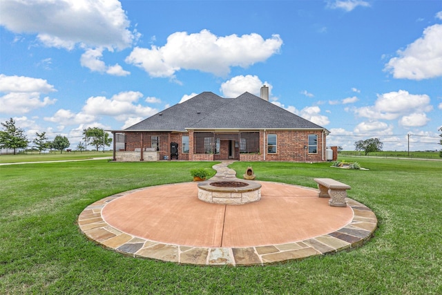 back of property featuring a patio, a lawn, and a fire pit