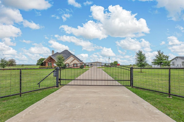 view of gate featuring a yard