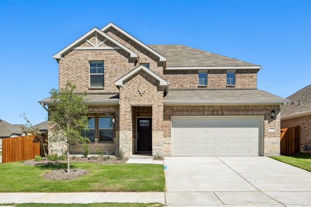 view of front facade with a front yard and a garage