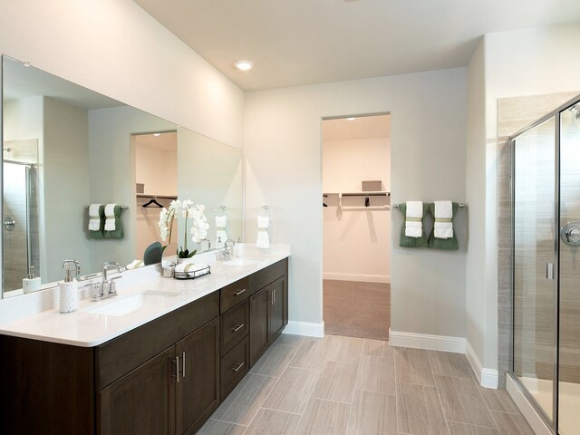 bathroom featuring vanity and an enclosed shower