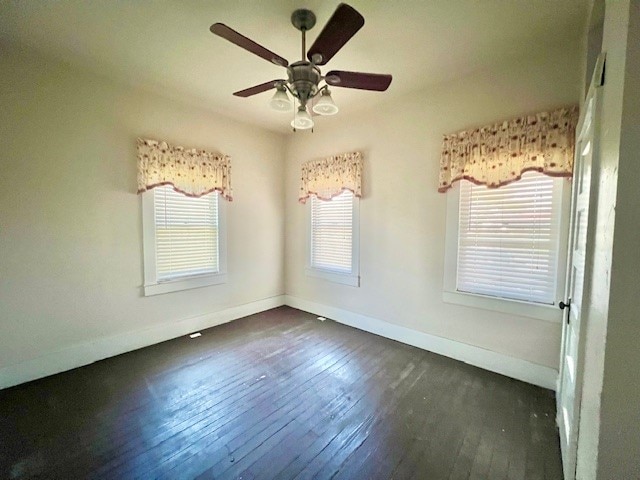 spare room with ceiling fan and dark hardwood / wood-style floors