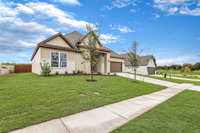 view of front of house with a front yard and a garage