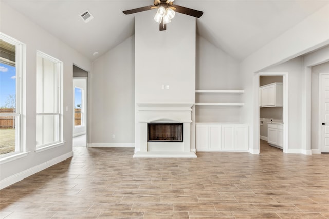 unfurnished living room featuring light hardwood / wood-style flooring, lofted ceiling, and ceiling fan