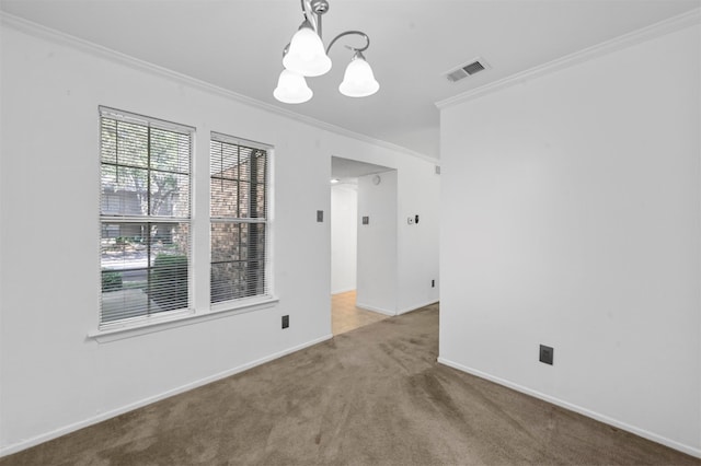 carpeted empty room with an inviting chandelier and crown molding