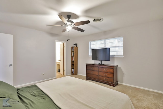 carpeted bedroom with ceiling fan and ensuite bathroom