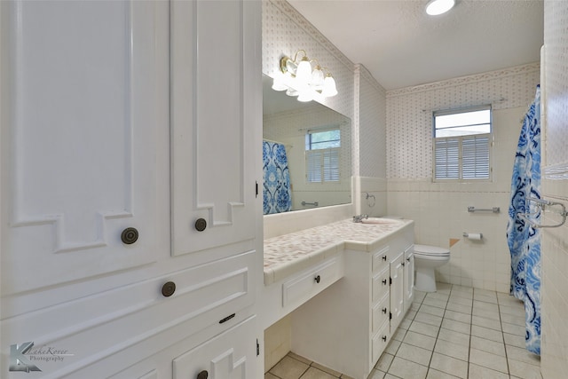 bathroom featuring tile walls, tile patterned flooring, a shower with curtain, vanity, and toilet