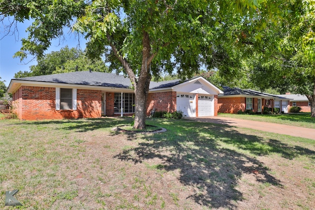 single story home featuring a garage and a front lawn