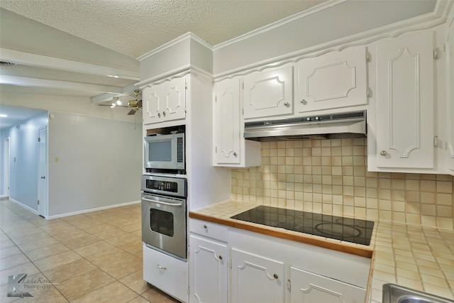 kitchen featuring decorative backsplash, stainless steel appliances, white cabinets, and tile counters