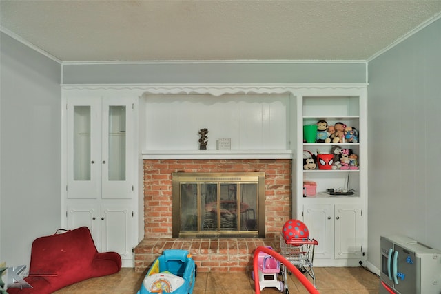 rec room with a brick fireplace, a textured ceiling, ornamental molding, and tile patterned floors