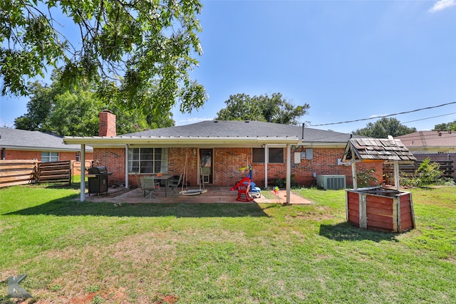 back of house featuring cooling unit, a yard, and a patio area