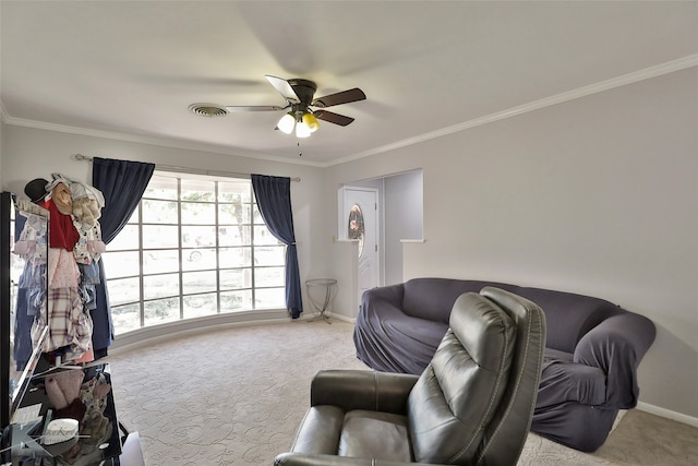 carpeted living room with ceiling fan and ornamental molding