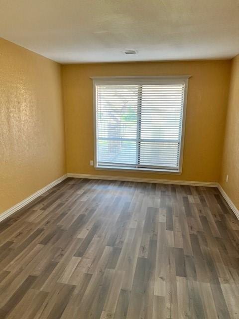 spare room featuring dark hardwood / wood-style flooring