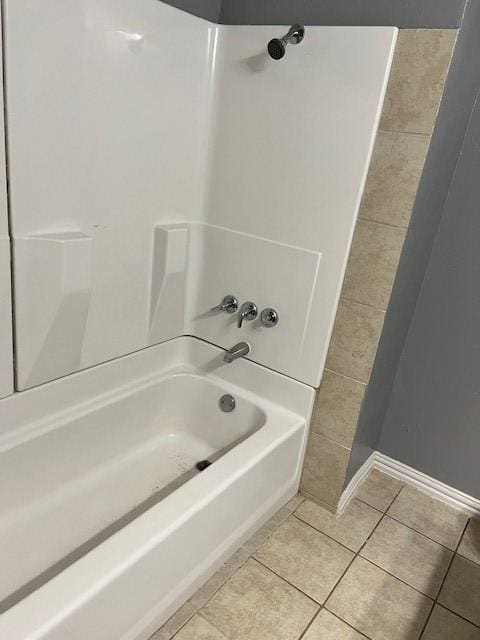 bathroom with tile patterned flooring and bathtub / shower combination