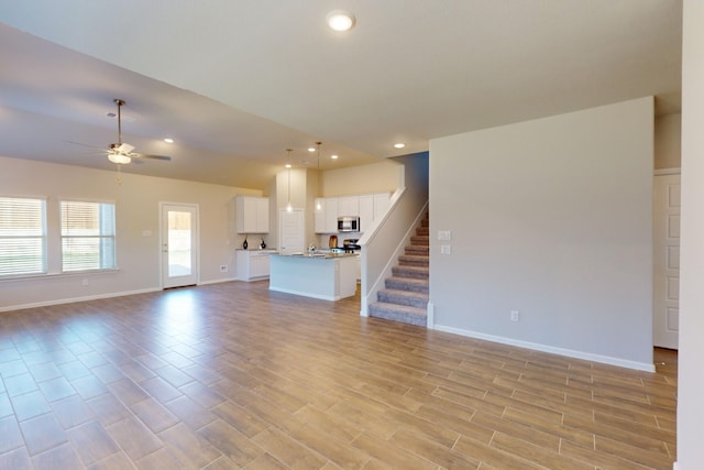 unfurnished living room featuring ceiling fan