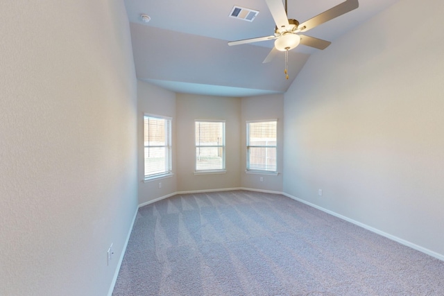 empty room featuring ceiling fan, lofted ceiling, and carpet flooring