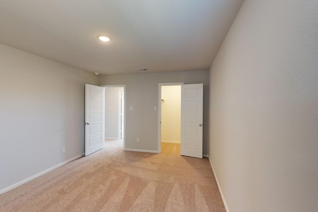 unfurnished bedroom featuring light carpet