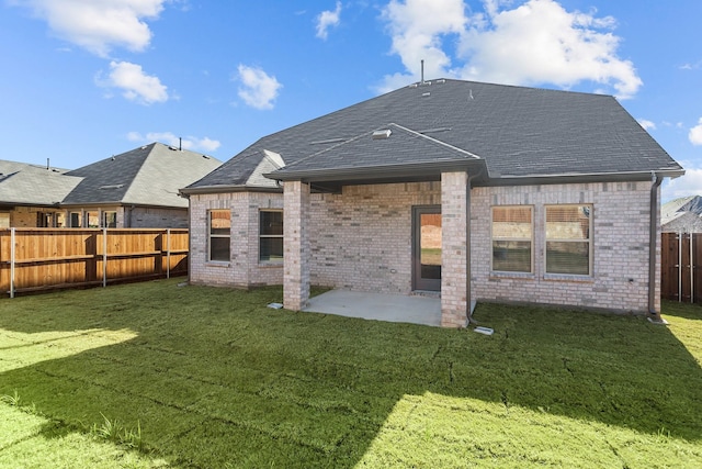 back of house with a lawn and a patio area