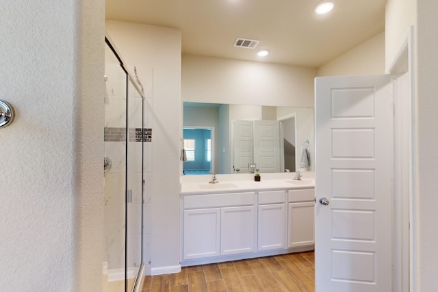 bathroom with walk in shower and vanity