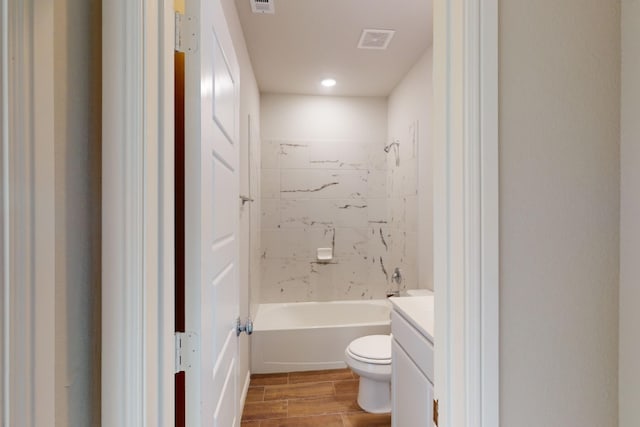 full bathroom with toilet, tiled shower / bath combo, and vanity