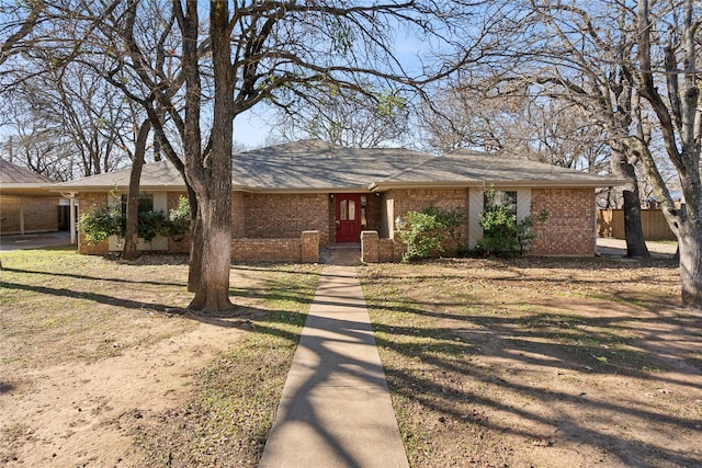 ranch-style home featuring a carport and a front lawn