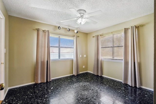 unfurnished room with a textured ceiling and ceiling fan