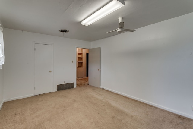 empty room featuring light carpet and ceiling fan