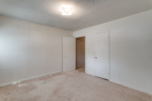 unfurnished room with light carpet