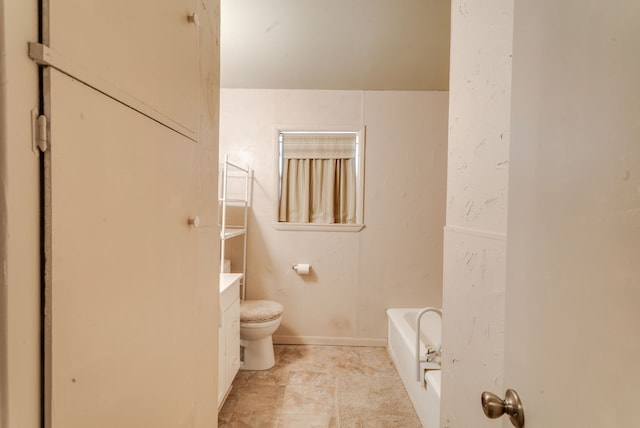 bathroom featuring a washtub, vanity, and toilet