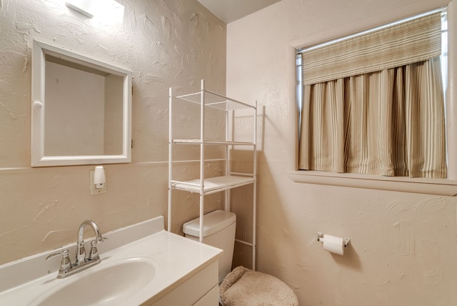 bathroom with toilet and vanity