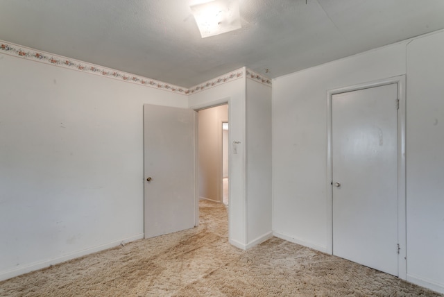 unfurnished bedroom with light colored carpet