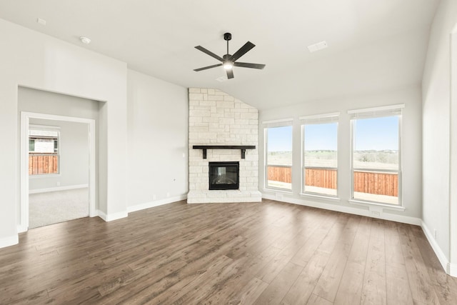 unfurnished living room featuring a fireplace, ceiling fan, lofted ceiling, and dark hardwood / wood-style flooring