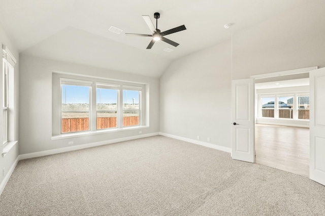 spare room with light carpet, lofted ceiling, and ceiling fan