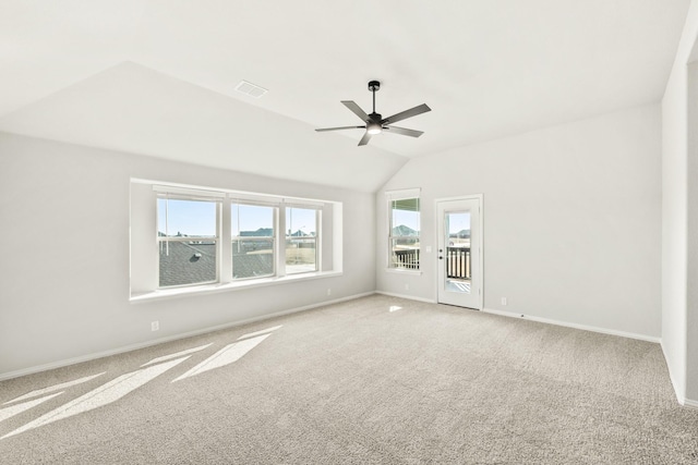 spare room featuring carpet, vaulted ceiling, and ceiling fan