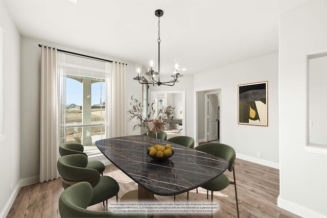 dining space with hardwood / wood-style flooring and a notable chandelier