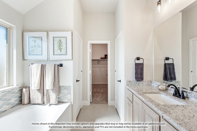 bathroom with vanity, lofted ceiling, and tile patterned flooring