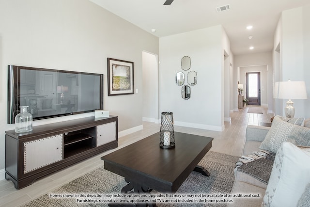 living room with light wood-type flooring and ceiling fan