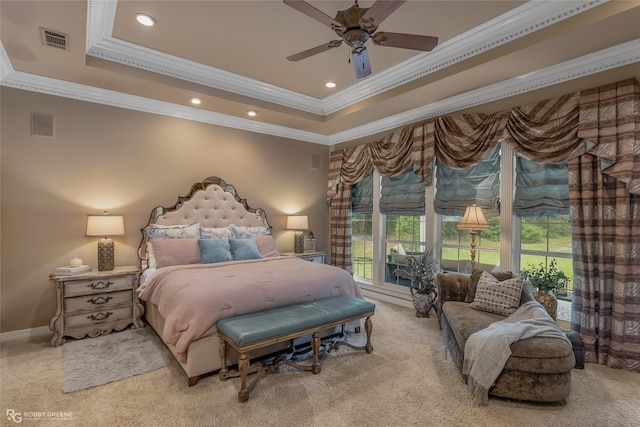 bedroom featuring ceiling fan, carpet floors, a tray ceiling, and ornamental molding