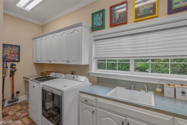 laundry room with cabinets, independent washer and dryer, crown molding, and sink