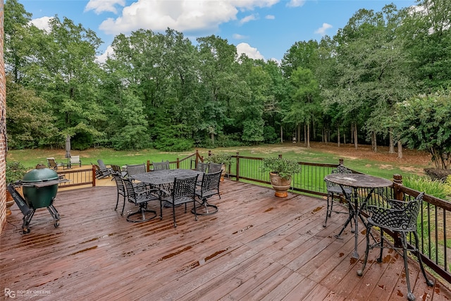 wooden deck with a lawn and area for grilling