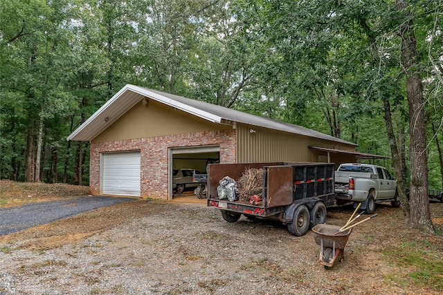 view of side of property with a garage and an outdoor structure