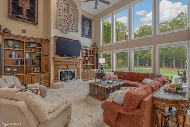 living room featuring a high ceiling, ceiling fan, and carpet flooring