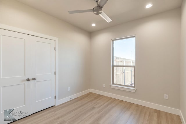 spare room with a ceiling fan, recessed lighting, light wood-style flooring, and baseboards