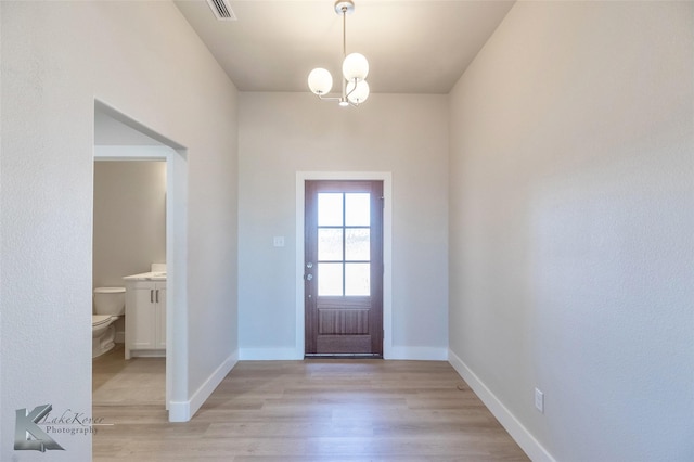 entrance foyer featuring light wood finished floors, visible vents, and baseboards