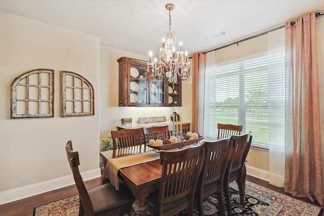 dining room featuring dark wood-type flooring and a notable chandelier