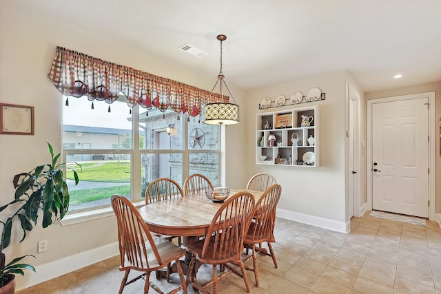 tiled dining area featuring a wealth of natural light