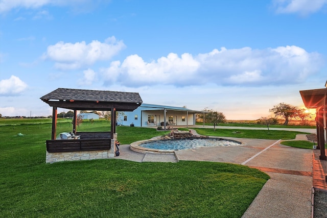 view of swimming pool with a yard and a patio area