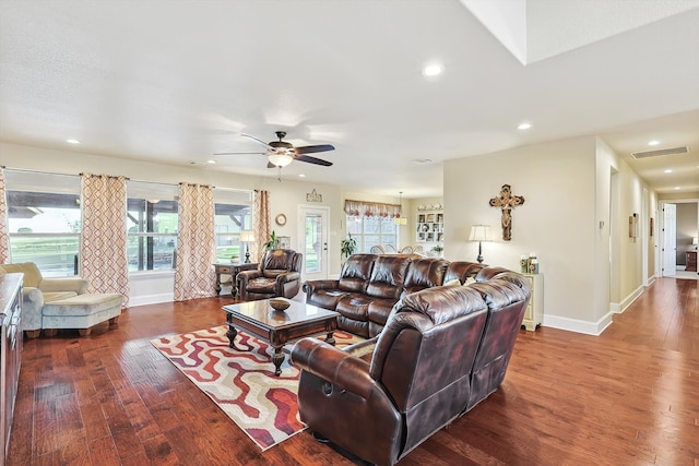 living room with dark wood-type flooring and ceiling fan