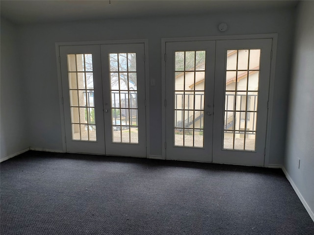 doorway with dark carpet and french doors